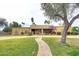Charming single-story home with a well-manicured lawn and inviting walkway leading to the entrance at 10365 E Paradise Dr, Scottsdale, AZ 85260