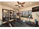Spacious home gym equipped with various workout machines and large mirrors at 10365 E Paradise Dr, Scottsdale, AZ 85260