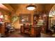 Elegant home office with rich wood desk, carved wall mirror, and classic decor accents at 10365 E Paradise Dr, Scottsdale, AZ 85260