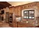 Stylish kitchen highlighting custom wood cabinets, granite countertops, stainless steel appliances and backyard pool view at 10365 E Paradise Dr, Scottsdale, AZ 85260
