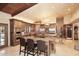 Modern kitchen featuring custom wood cabinets, granite countertops, stainless steel appliances and a center island at 10365 E Paradise Dr, Scottsdale, AZ 85260