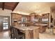 Gourmet kitchen featuring custom wood cabinets, granite countertops, stainless steel appliances and a large island at 10365 E Paradise Dr, Scottsdale, AZ 85260