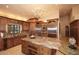 Beautiful kitchen boasting custom wood cabinets, granite countertops, and stainless steel appliances and island at 10365 E Paradise Dr, Scottsdale, AZ 85260