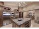 Gourmet kitchen with custom cabinetry, granite counters, and stainless steel refrigerator at 10365 E Paradise Dr, Scottsdale, AZ 85260
