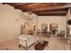 Beautifully decorated living area showcasing wood beamed ceilings, neutral decor, and travertine flooring at 10365 E Paradise Dr, Scottsdale, AZ 85260