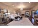 Luxurious main bedroom with a fireplace, chandelier, and a seating area with a plush rug at 10365 E Paradise Dr, Scottsdale, AZ 85260