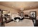 Spacious main bedroom with a cozy fireplace and elegant chandelier at 10365 E Paradise Dr, Scottsdale, AZ 85260