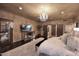 Bright main bedroom featuring a chandelier, mirrored furniture, and wood flooring at 10365 E Paradise Dr, Scottsdale, AZ 85260