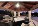 Stylish outdoor living area features a built-in grill, cozy seating, and a fireplace for year-round enjoyment at 10365 E Paradise Dr, Scottsdale, AZ 85260