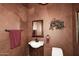 Stylish powder room with unique decor and a modern sink at 10365 E Paradise Dr, Scottsdale, AZ 85260