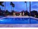 Stunning backyard pool at twilight features a covered patio area perfect for outdoor entertaining at 10365 E Paradise Dr, Scottsdale, AZ 85260