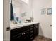 Bathroom features a white quartz countertop, dark brown cabinets, and three framed pictures at 10635 W Eucalyptus Rd, Peoria, AZ 85383