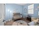 Charming Bedroom with a gray crib, soft blue walls, and a playful animal-themed rug at 10635 W Eucalyptus Rd, Peoria, AZ 85383