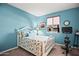 Cozy bedroom with a white bed, patterned bedding, blue walls, and a view of the neighborhood at 10635 W Eucalyptus Rd, Peoria, AZ 85383