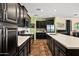 Modern kitchen with stainless steel appliances, white countertops, and sleek, dark cabinetry at 10635 W Eucalyptus Rd, Peoria, AZ 85383
