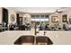 Stylish open-concept kitchen featuring modern sink fixtures and views of the dining and living areas at 10635 W Eucalyptus Rd, Peoria, AZ 85383