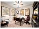 Home office with dark wood desk, leather chair, and decorative maps and art at 10635 W Eucalyptus Rd, Peoria, AZ 85383