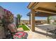 Inviting covered patio with travertine tile, water feature, grill and beautiful landscaping at 10635 W Eucalyptus Rd, Peoria, AZ 85383
