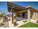 Large patio with travertine tile, water feature, outdoor seating, grill, and desert views at 10635 W Eucalyptus Rd, Peoria, AZ 85383