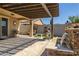 Relaxing outdoor space with waterfall, grill, pergola, and artificial turf at 10635 W Eucalyptus Rd, Peoria, AZ 85383