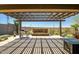 Covered patio with travertine tile, water feature, grill, and mountain views at 10635 W Eucalyptus Rd, Peoria, AZ 85383