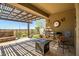 Inviting covered patio features a pergola, water feature, and comfortable seating area at 10635 W Eucalyptus Rd, Peoria, AZ 85383