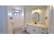 Bright bathroom featuring a modern vanity with white cabinets and a quartz countertop, complemented by a sleek, arched mirror at 11142 E Copper Dust Trl, Florence, AZ 85132