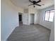 Spacious bedroom with sleek flooring, a modern ceiling fan, and a closet, offering a blend of comfort and style at 11142 E Copper Dust Trl, Florence, AZ 85132