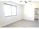 Sunlit bedroom featuring sleek floors and a view into a modern bathroom with a vanity and an arched mirror at 11142 E Copper Dust Trl, Florence, AZ 85132