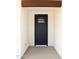 Inviting front door entry with a modern black door and minimalist design, creating a welcoming first impression at 11142 E Copper Dust Trl, Florence, AZ 85132