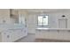 Bright, modern kitchen featuring white cabinets, stainless steel appliances, subway tile backsplash and large island at 11142 E Copper Dust Trl, Florence, AZ 85132