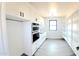 Bright pantry area boasting custom white cabinets and shelving, a sleek sink, and durable floors at 11142 E Copper Dust Trl, Florence, AZ 85132
