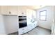 Well-lit pantry featuring custom white cabinets, sleek black hardware and durable floors at 11142 E Copper Dust Trl, Florence, AZ 85132