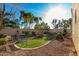 Well maintained backyard featuring desert landscaping, synthetic grass, and a sitting area at 11713 W Tonto St, Avondale, AZ 85323