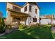 Backyard showcasing a covered patio with a table, chairs, and synthetic grass at 11713 W Tonto St, Avondale, AZ 85323