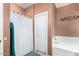 Bathroom with shower and tub, featuring privacy curtain and tile floors at 11713 W Tonto St, Avondale, AZ 85323
