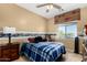 Inviting bedroom with ceiling fan and decorative window treatments at 11713 W Tonto St, Avondale, AZ 85323