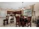 Dining area in the kitchen with a wooden table, chairs, and chandelier at 11713 W Tonto St, Avondale, AZ 85323