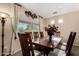 Formal dining room with a large window, classic decor, and seating for eight at 11713 W Tonto St, Avondale, AZ 85323