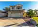 Inviting two-story home with neutral siding, a two-car garage, and well-maintained landscaping at 11713 W Tonto St, Avondale, AZ 85323