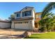 Delightful two-story home showcasing tidy landscaping and a spacious driveway that leads to a two-car garage at 11713 W Tonto St, Avondale, AZ 85323