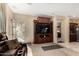 Living room featuring a large entertainment center, plush seating, and a view to the outside at 11713 W Tonto St, Avondale, AZ 85323