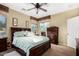 Well-lit main bedroom featuring neutral paint, ceiling fan, and warm interior design at 11713 W Tonto St, Avondale, AZ 85323