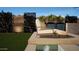 Inviting backyard oasis with lounge chairs, custom screens, water feature, and manicured landscaping at 12328 E Black Rock Rd, Scottsdale, AZ 85255