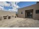 Backyard featuring a stone patio, outdoor kitchen, and a large sliding glass door at 12328 E Black Rock Rd, Scottsdale, AZ 85255