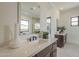 Bright bathroom featuring double sinks with modern fixtures and contrasting dark wood cabinets at 12328 E Black Rock Rd, Scottsdale, AZ 85255