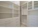 Organized walk-in closet with adjustable shelving, drawers, and ample storage space at 12328 E Black Rock Rd, Scottsdale, AZ 85255
