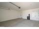 Spacious two car garage with concrete floors, a water softener, and white walls at 12328 E Black Rock Rd, Scottsdale, AZ 85255