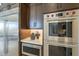 Modern kitchen showcasing stainless steel appliances, including a refrigerator, microwave, and double oven at 12328 E Black Rock Rd, Scottsdale, AZ 85255