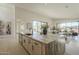 Open-concept kitchen featuring a large island, modern appliances, stylish lighting, and bright view through large windows at 12328 E Black Rock Rd, Scottsdale, AZ 85255